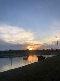 Scenic view of river against sky during sunset