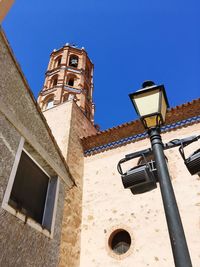 Low angle view of old building against clear blue sky