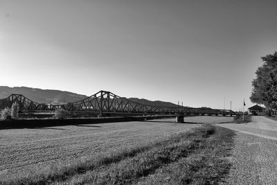 View of bridge over field against clear sky