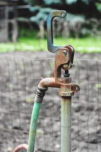 Close-up of faucet on field