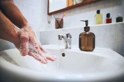 Midsection of woman in bathroom at home