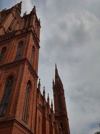 Low angle view of building against cloudy sky