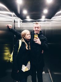 Friends taking selfie in elevator