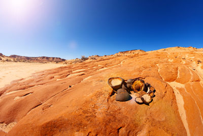 Rocks in desert against clear blue sky