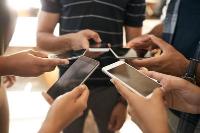 Midsection of man using mobile phone