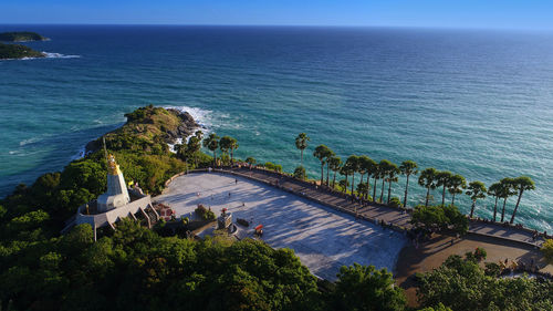 High angle view of trees and sea against sky