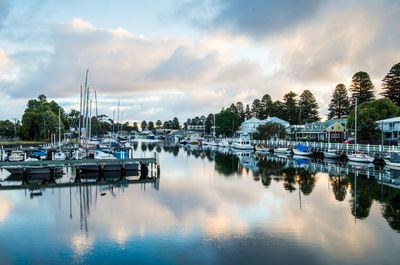 Scenic view of marina against sky during sunset