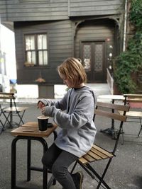 Side view of woman using drinking tee