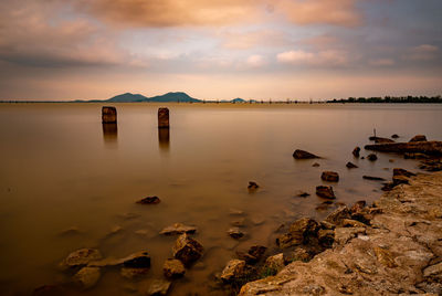 Scenic view of lake against sky during sunset