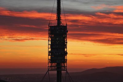 Silhouette tower against sky during sunset