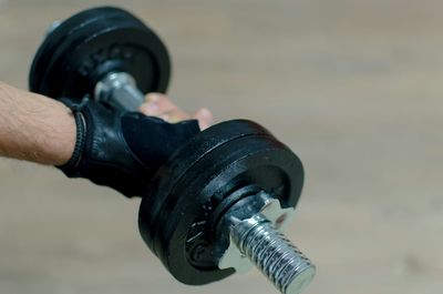 Cropped image of hand holding dumbbell