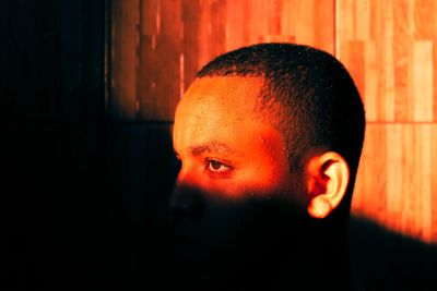 Close-up of teenage boy in darkroom