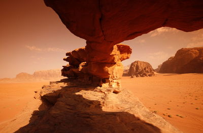 Rock formation in desert against sky