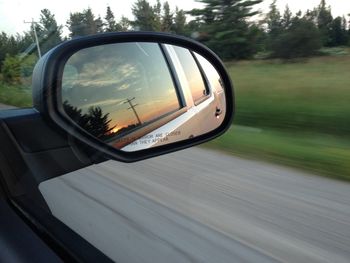 Reflection of electric pole on side-view mirror
