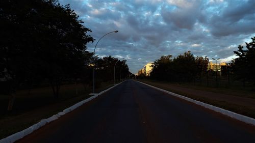 Road amidst trees against sky