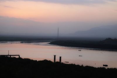 Scenic view of lake against sky during sunset