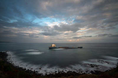 Scenic view of sea against sky at sunset