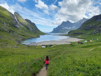 Rear view of person on mountains against sea and sky