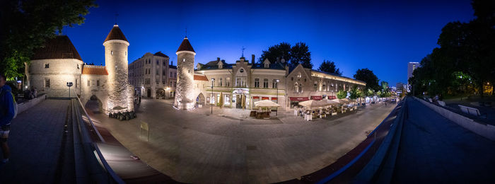 Panoramic view of buildings in city at night