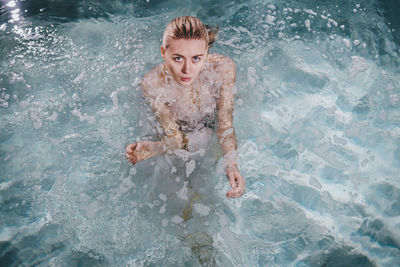 High angle portrait of woman swimming in pool