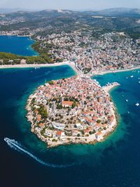 Aerial view of city by sea