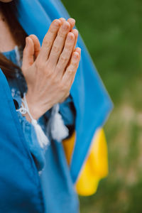 Midsection of woman with hands clasped