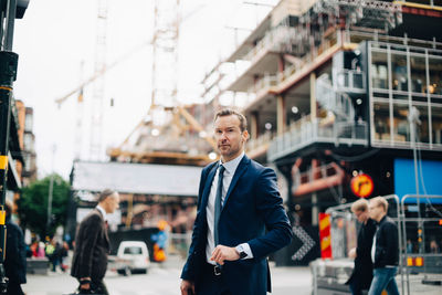 Full length of young man standing in city