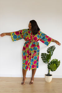 Full length of woman standing against white background