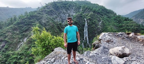 Full length of young man standing on rock