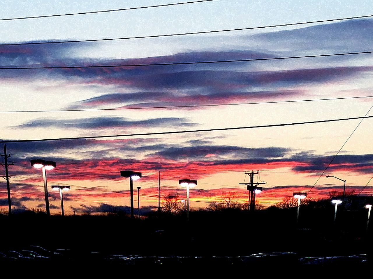 power line, electricity pylon, sunset, power supply, electricity, cable, sky, connection, fuel and power generation, railroad track, cloud - sky, power cable, landscape, orange color, technology, silhouette, built structure, no people, rail transportation, street light