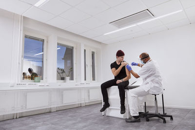Young man getting vaccinated against covid-19