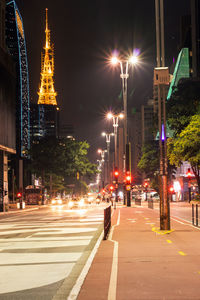 Illuminated city street at night