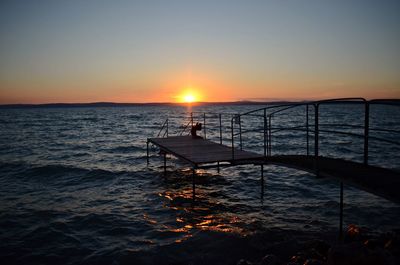 Scenic view of sea against clear sky during sunset