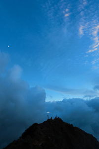 Scenic view of mountains against cloudy sky