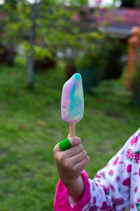 Cropped hand holding ice cream cone