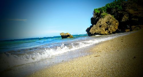 Scenic view of beach against clear sky