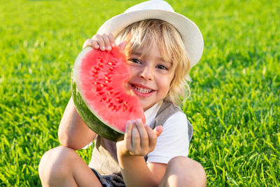 Portrait of happy boy eating apple