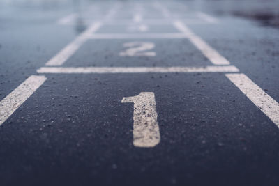 Close-up of number one on asphalt
