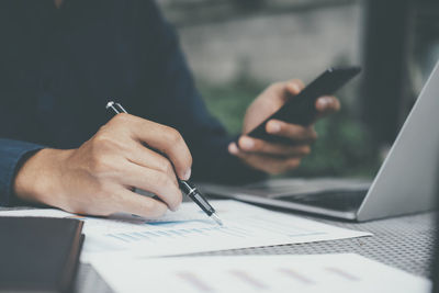 Closeup businessman working with modern device