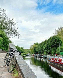 Scenic view of river against cloudy sky