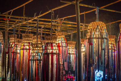 Low angle view of illuminated lanterns hanging in store