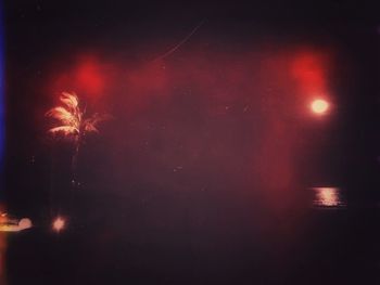 Low angle view of illuminated lights at night