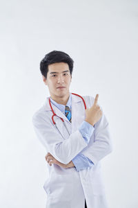 Young man standing against white background