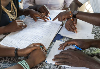 Cropped hand of people with documents working at office