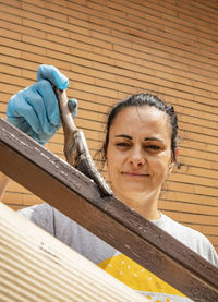 Portrait of woman working on wood