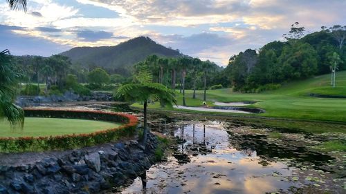 Scenic view of golf course against sky