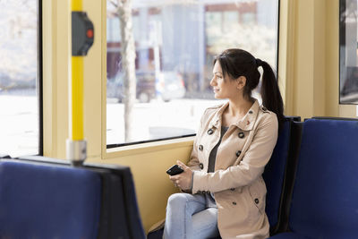 Woman with cellphone in tram
