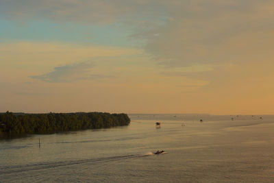 Scenic view of beach against sky during sunset