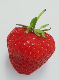 Close-up of red strawberry over white background