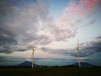 Low angle view of windmill on field against sky